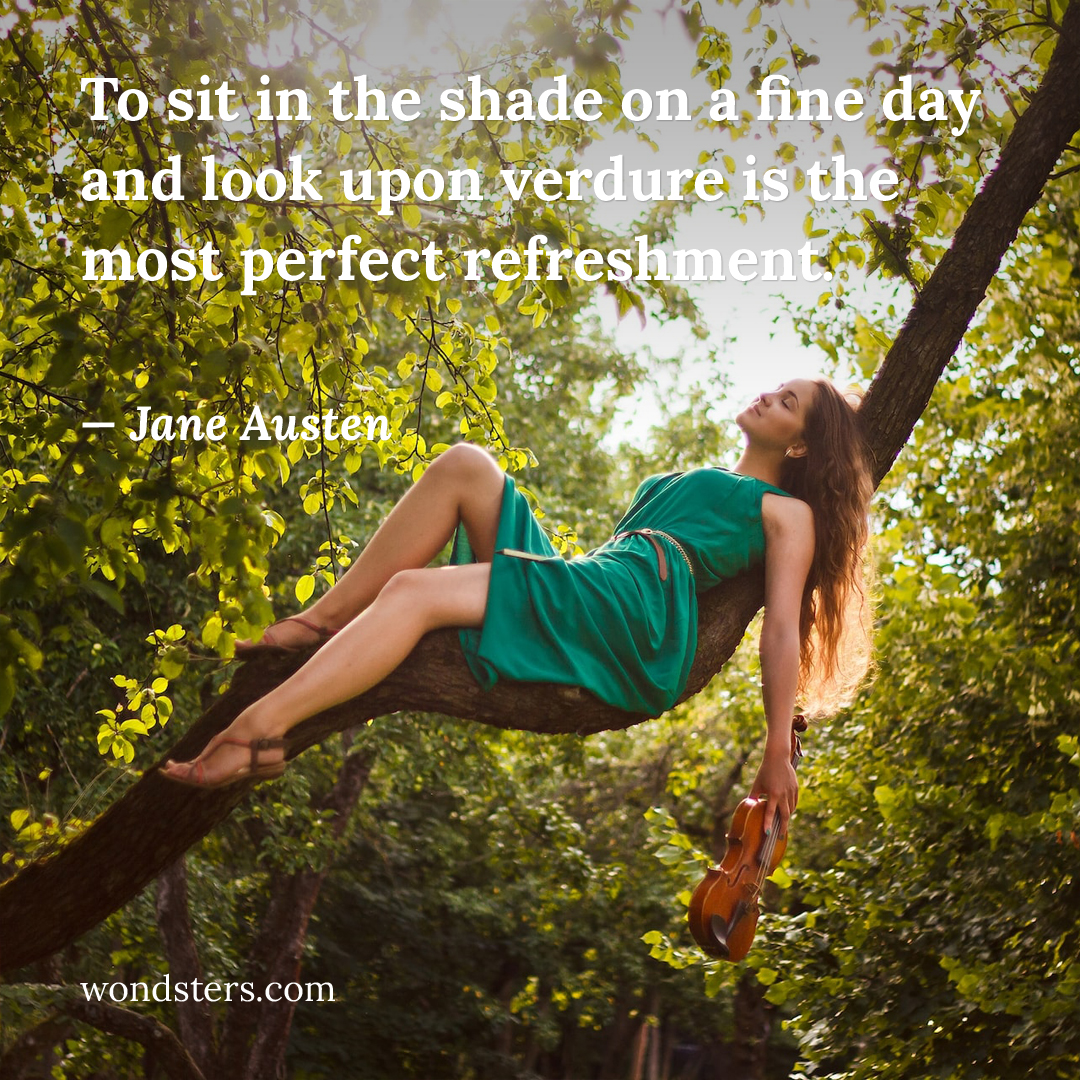 woman is sitting on a branch in the shade of a tree